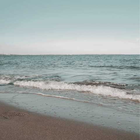 Feel the sand beneath your feet on the beach, only 250 metres away