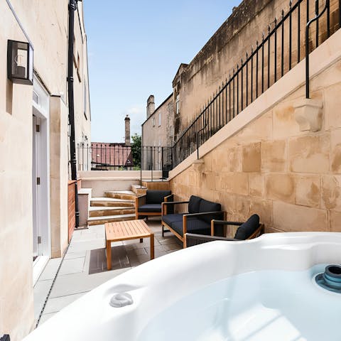 Unwind in the hot tub in the private courtyard garden