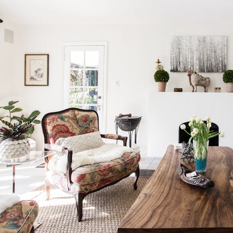 Admire the curiosities of the living space from the comfort of the antique armchair