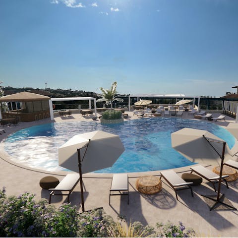 Hang out by the communal swimming pool on a scorching afternoon