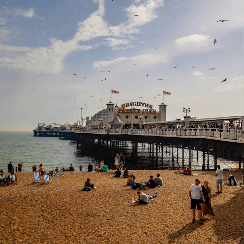 Stroll for half an hour along the seafront to the storied Brighton Pier