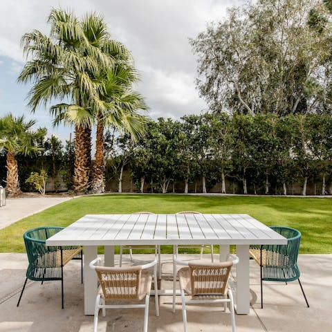 Enjoy an alfresco lunch in the palm-lined garden-patio area