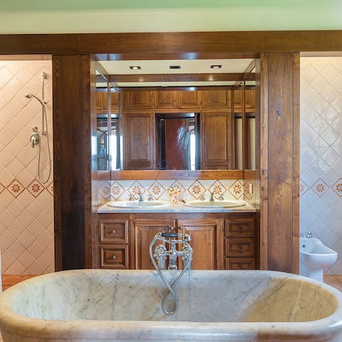 Treat yourself to an indulgent soak in the elegant marble bathtub