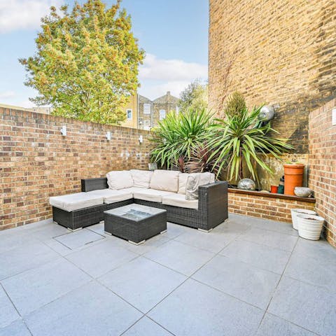 Unwind in the secluded patio garden when the sun is shining