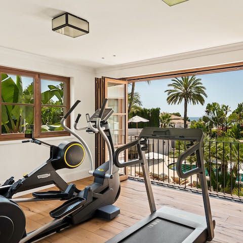 Work out with a sparkling sea view from the fitness room