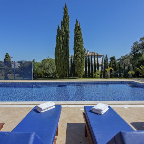 Relax on the peaceful poolside patio before enjoying a dip in the beautiful blue waters
