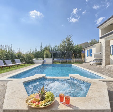 Dip your toes in the pool as you watch your children play on the trampoline