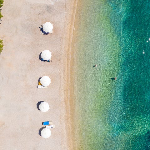 Follow the private path down to the crystalline shallows of Polis Beach