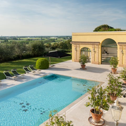 Cool off in the outdoor pool, surrounded by cypress trees and rolling hills