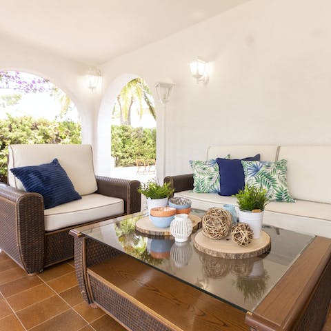 Share an aperitif paired with Spanish wine at the outdoor lounge