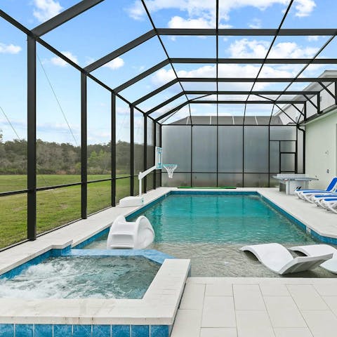 Splash and relax in the private pool with hot tub and basketball hoop