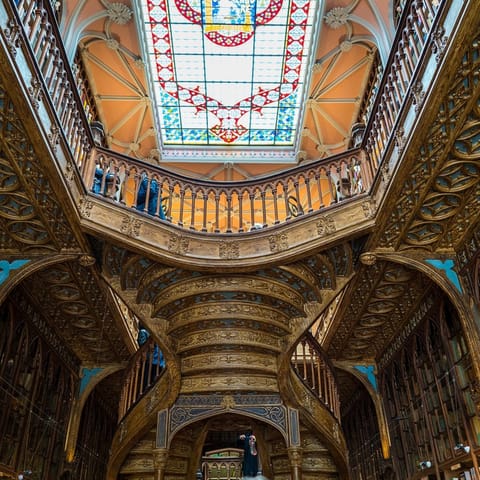 Admire the ornate interiors of the Livraria Lello bookshop, three minutes away on foot