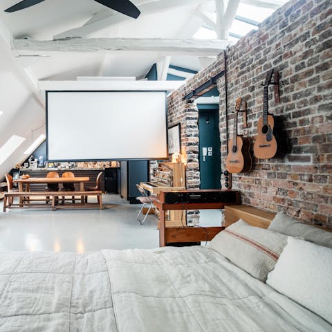 Unwind with a movie on the projector in this loft-style apartment