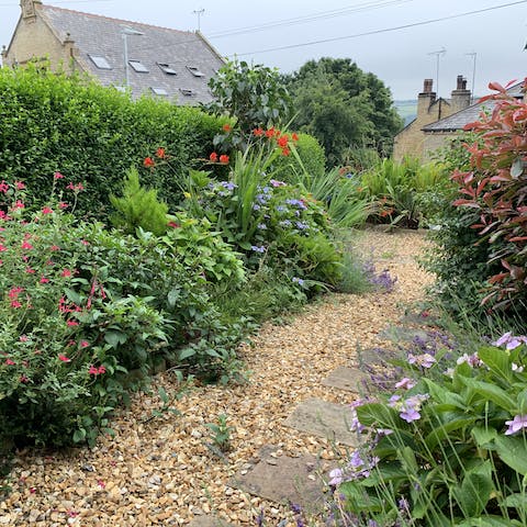 Sit out among the flowerbeds in the south-facing front garden