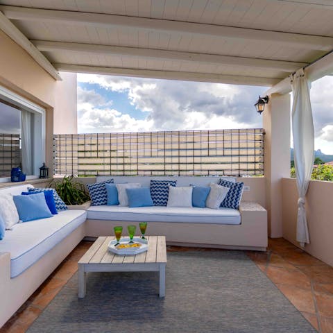 Admire the view of Porto Retondo from the terrace