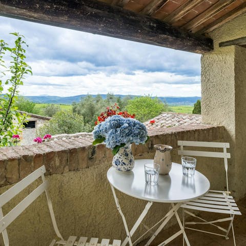 Enjoy an Aperol Spritz on the covered balcony