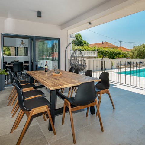 Gather around the outdoor dining table for barbecue dinners at home, washed down with local wine
