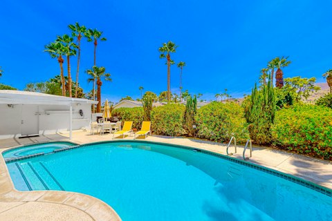 Cool off in the pool beneath endless Palm Springs blue skies