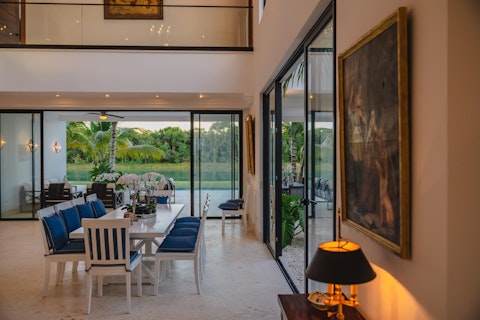 Dine with lagoon views framed by floor-to-ceiling glass doors