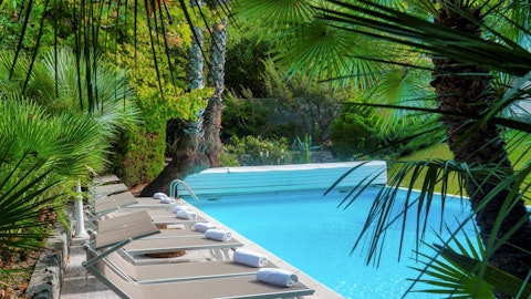 Stretch out on a lounger beneath swaying palms poolside