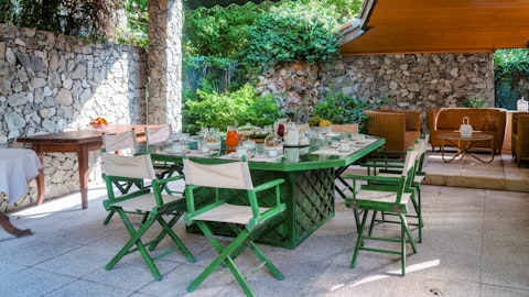 Gather at the alfresco dining table for long lunches in dappled light