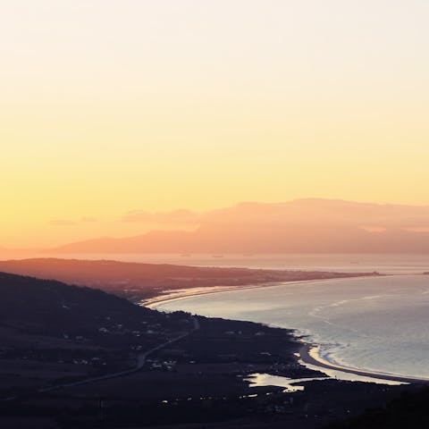 Enjoy a stroll along the sands of Torrox Beach at the golden hour, a short drive from your home