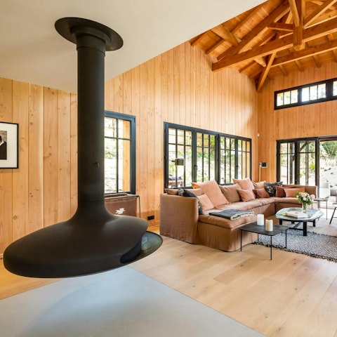 Sip local wine beside the suspended fireplace