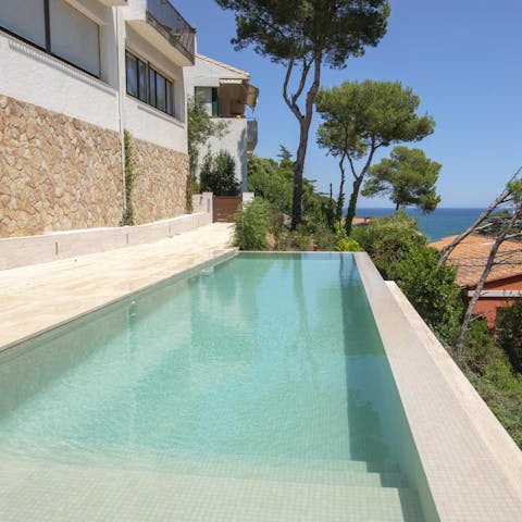 Take a dip in the shared infinity pool with a sea view