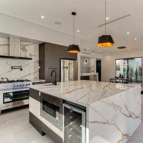 Prepare indulgent dinners for your loved ones in your sleek marble kitchen