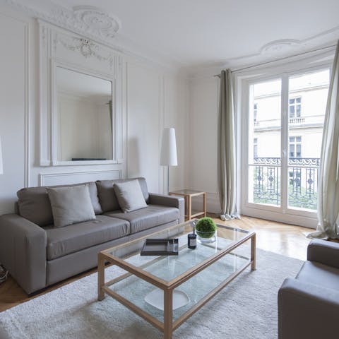 Stretch out in the plush living area after a day of discovering the shops and museums of Paris