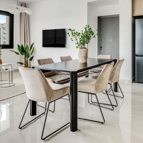 Pull up a chair at the dining table in a bright, modern setting