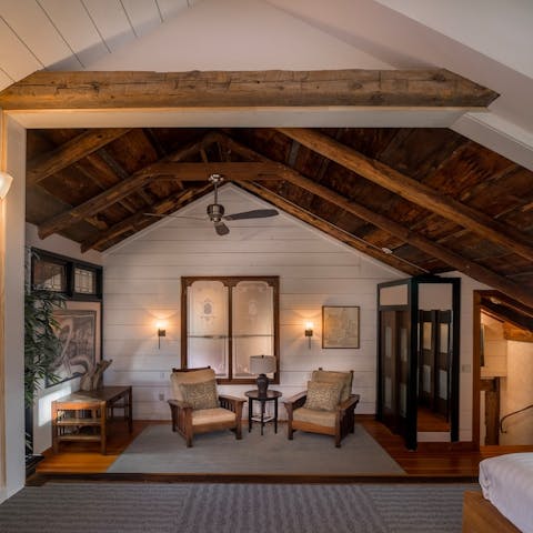 Share a bottle of wine with your loved one in the private living area in the master bedroom