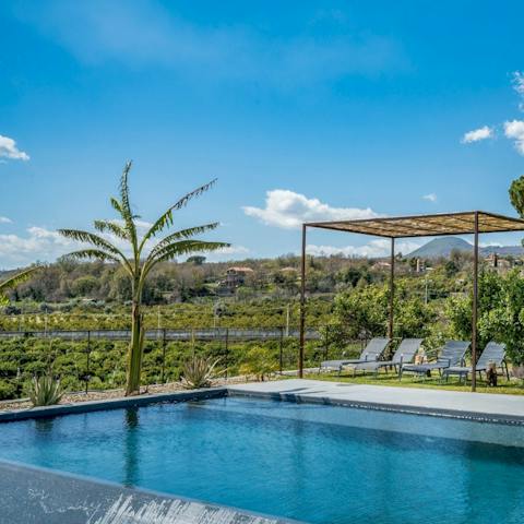 Enjoy beautiful views while relaxing by the pool