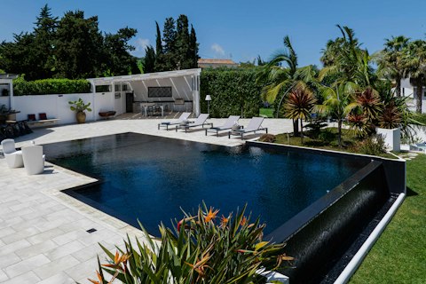 Cool off in the dark-tiled pool ringed by lush greenery