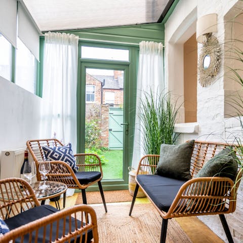 Take a load off in the conservatory – we think it's the perfect spot to enjoy a glass of wine and a good book