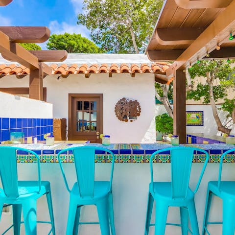 Perch at the bar and enjoy homemade cocktails in the sun