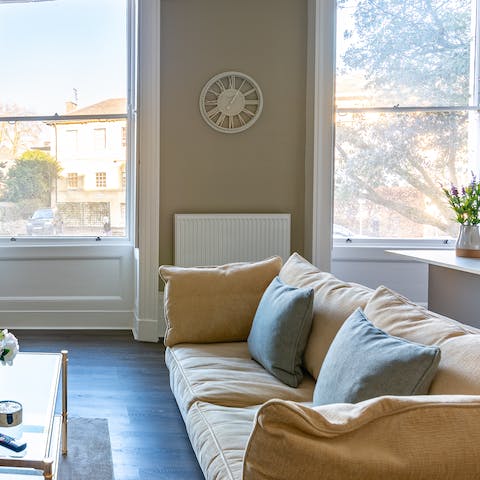 Relax on the plush sofa next to the original sash windows