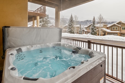 Soak in bubbling hot tub with snow-dusted mountain views