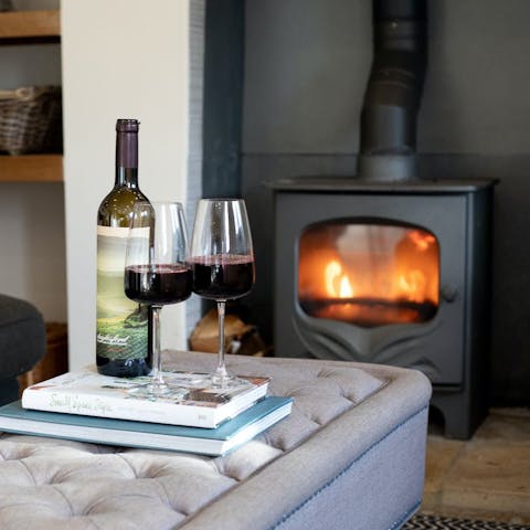 Curl up by the living room's fire with a glass of wine on cooler evenings