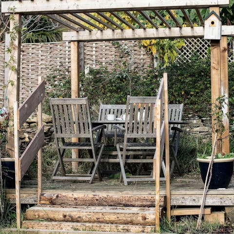 Enjoy an alfresco barbecue beneath the garden's pergola