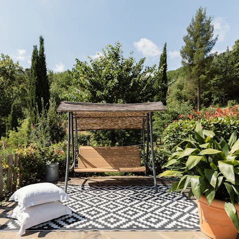 Relax with a book on the swinging chair in the garden