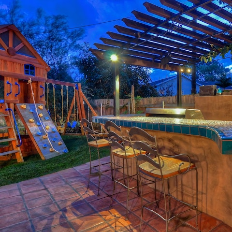 Rustle up a barbecue at the outdoor kitchen-bar area, while the kids have fun at the home playground