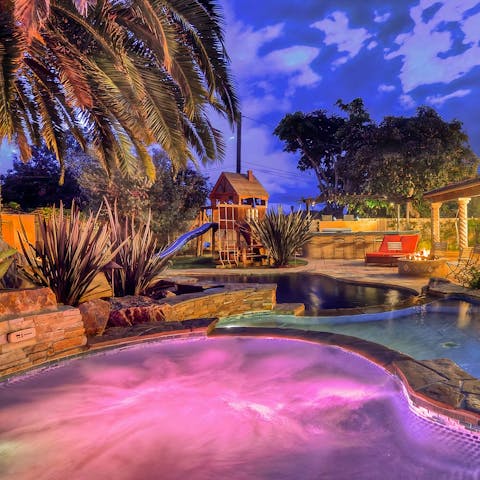 Unwind in the resort style hot tub after a day of discovering the beach, only a four minute drive away