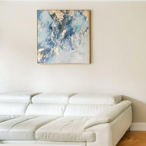 Sink into the white leather sofa and rest weary legs