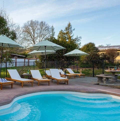 Chat with friends over a shared bottle of wine by the peaceful swimming pool