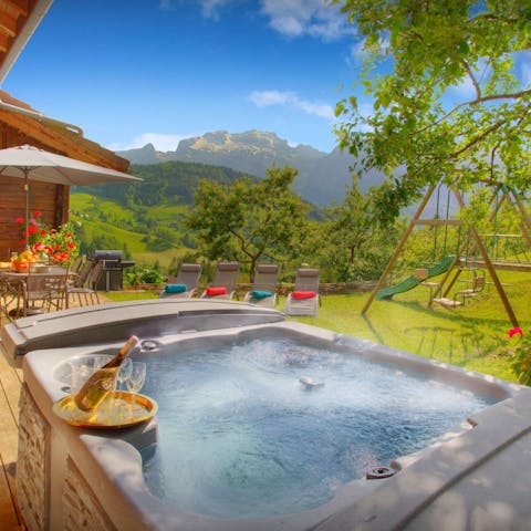 Enjoy a relaxing soak in the hot tub while the kids play on the swings