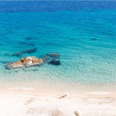 Sink your feet into the sand at Agios Mamas beach