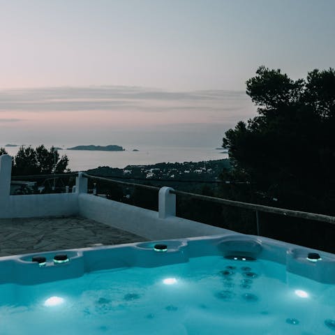Relax in the private hot tub overlooking the sea
