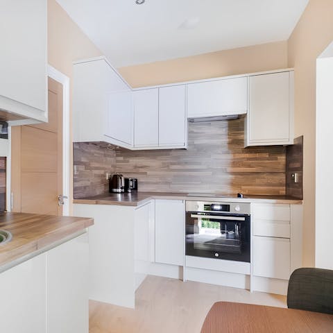 Fire up the coffee pod machine in the small but well-equipped kitchen space