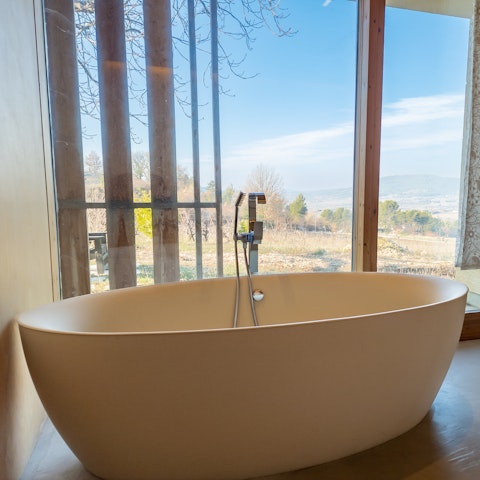 Take a relaxing soak in the freestanding bath with a view